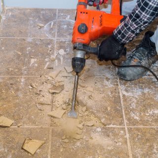 Renovation of old floor demolition old tiles with bath jackhammer